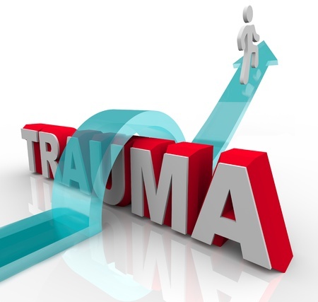 10265304 - a person jumps over the word trauma on an arrow, symbolizing the positive effects of theraphy and rehabilitation as well as a good attitude